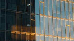 4K time lapse video with the shadows and light moving on the facade of an modern glass office skyscraper building