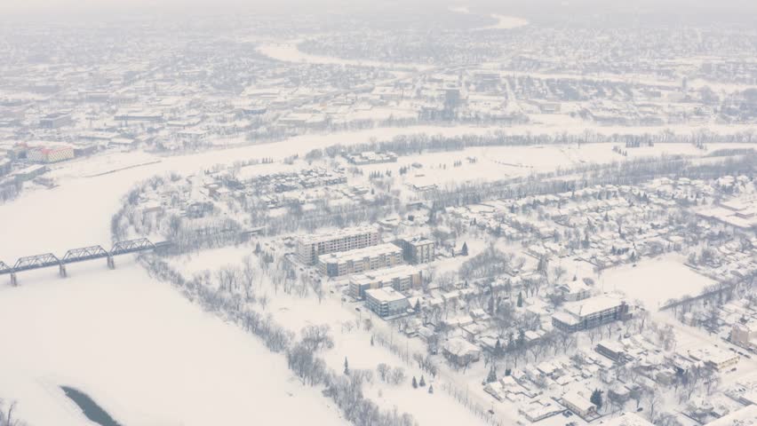 Red River in winter. Open water patch. Thin Ice. City wide shot.
