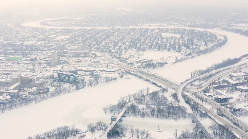 Static aerial shot of the red river snaking through Winnipeg Manitoba during an ice storm.