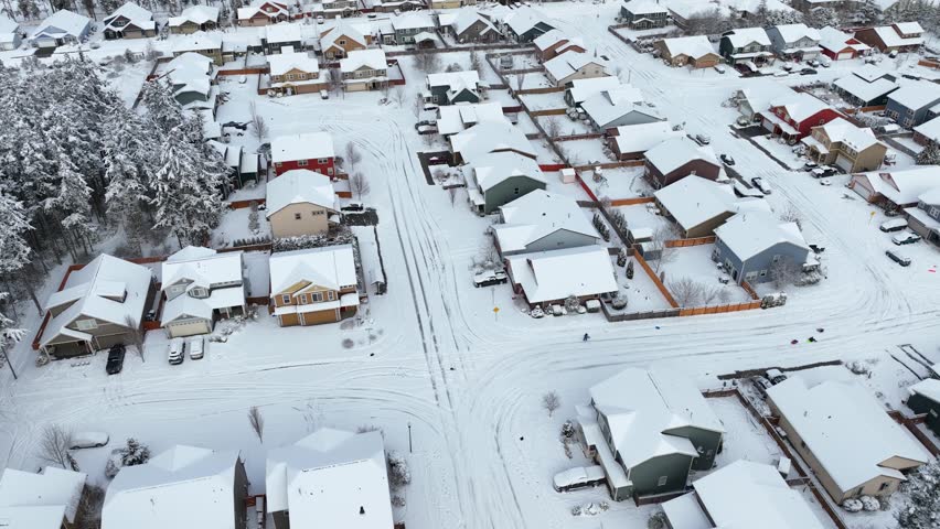 Drone shot of a suburban neighborhood in Washington State covered in a fresh blanket of snow.