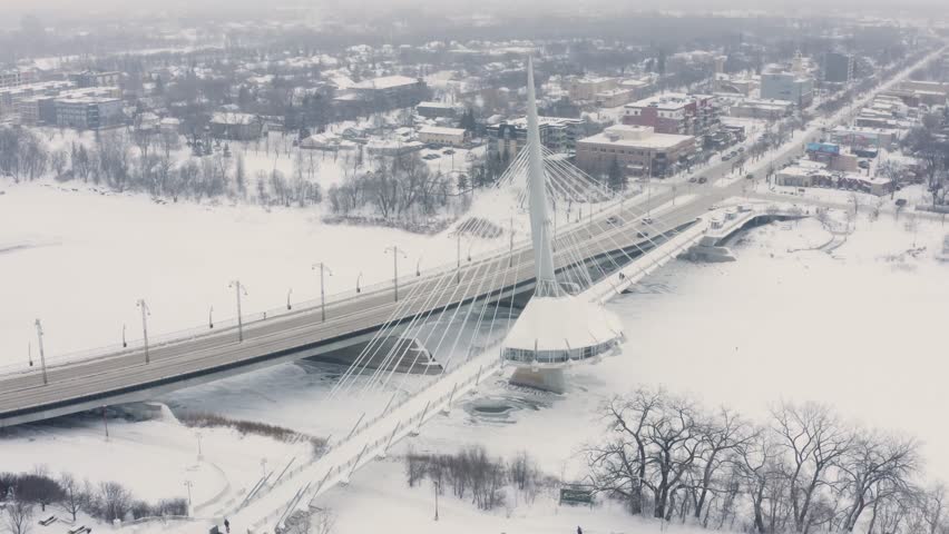 Walking bridge over the Red River in Winnipeg Manitoba Canada. Frozen River.