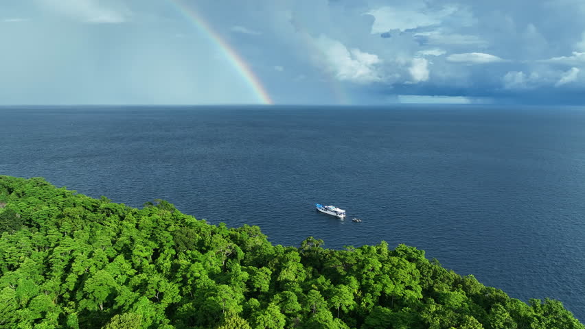 A beautiful rainbow appears near a lush, tropical island in the Solomon Islands. This South Pacific country is known for its spectacular marine biodiversity and its many historic World War II sites.