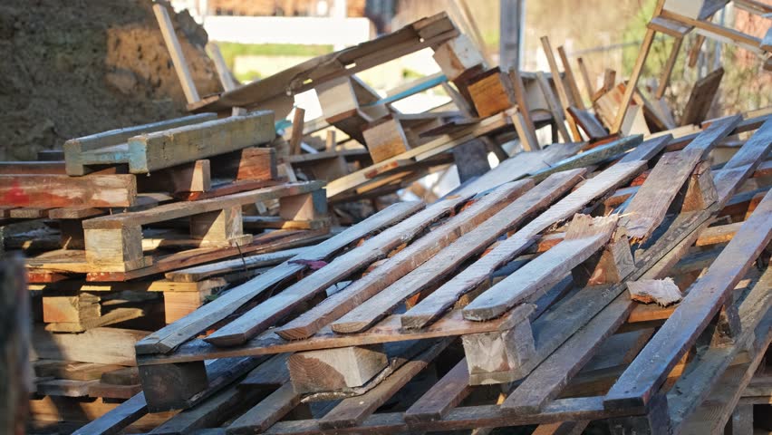 Messy Heap of Standardized Wooden Shipping Pallets Stored Outdoors | Shutterstock HD Video #1098691531