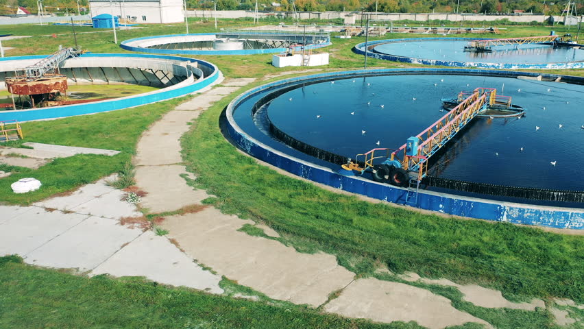 Several circular clarifiers at a large sewage treatment plant | Shutterstock HD Video #1098692531