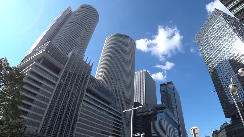 NAOGYA, JAPAN - OCTOBER 2022 : View of NAGOYA STATION and office buildings in daytime. Time lapse shot. Travel, tourism, business and transportation concept video.