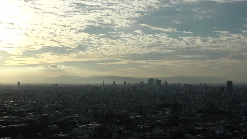 NAGOYA, JAPAN - OCTOBER 2022 : NAGOYA CITY in sunset. Aerial high angle view of buildings and street traffic around Nagoya station and Sakae area (central downtown). Time lapse shot, dusk to night.