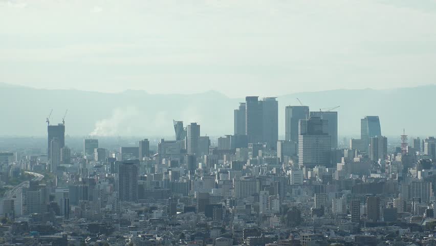 NAGOYA, JAPAN - OCTOBER 2022 : Aerial high angle view of NAGOYA CITY in sunny daytime. View of buildings and street traffic around Nagoya station and Sakae area (central downtown). Time lapse shot.
