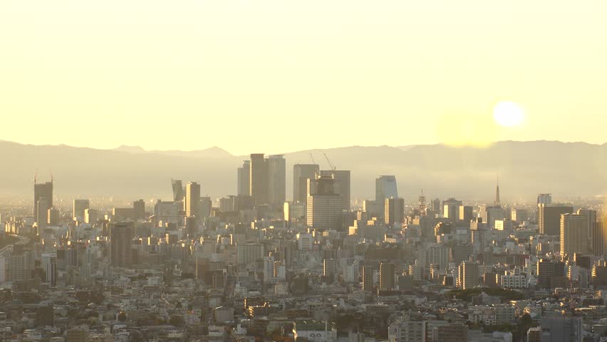 NAGOYA, JAPAN - OCTOBER 2022 : Aerial high angle view of NAGOYA CITY in sunset or sunrise. View of buildings and street traffic around Nagoya station and Sakae area (central downtown).
