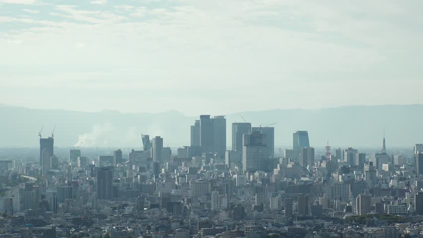 NAGOYA, JAPAN - OCTOBER 2022 : Aerial high angle view of NAGOYA CITY in sunny daytime. View of buildings and street traffic around Nagoya station and Sakae area (central downtown). Time lapse shot.