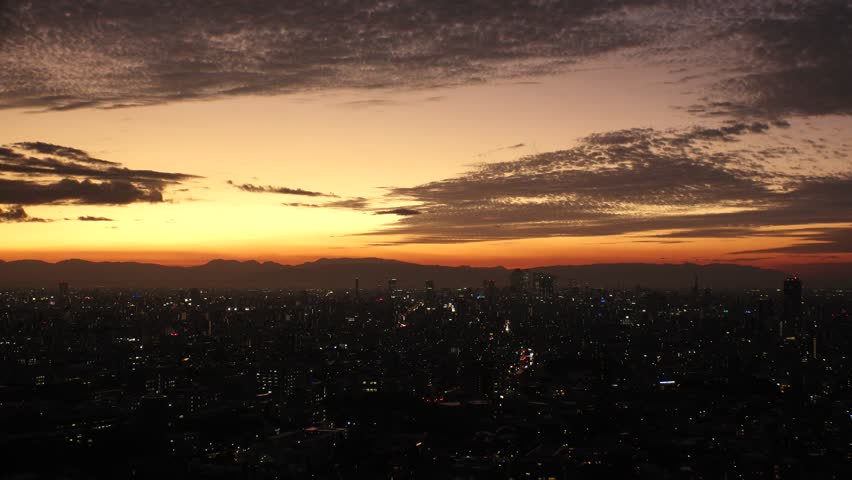 NAGOYA, JAPAN - OCTOBER 2022 : Aerial high angle view of NAGOYA CITY in sunset or sunrise. View of buildings and street traffic around Nagoya station and Sakae area (central downtown).