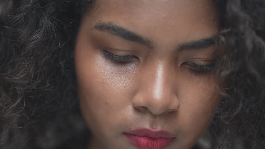 African woman using hand to manage the imagination of technology or hologram in the air.