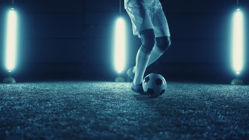 Football player practicing dribbling and dummy by feet and ball on field, closeup view | Shutterstock HD Video #1098698927