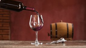 Hand hold glass to cheering and Drink glasses of red wine. Red wine pouring from bottle by winemaker to clear glass in vineyard vintage barrel winery. Pouring red wine into goblet on wood table  - Powered by Shutterstock - Get 15% off with code: PIKWIZARD15