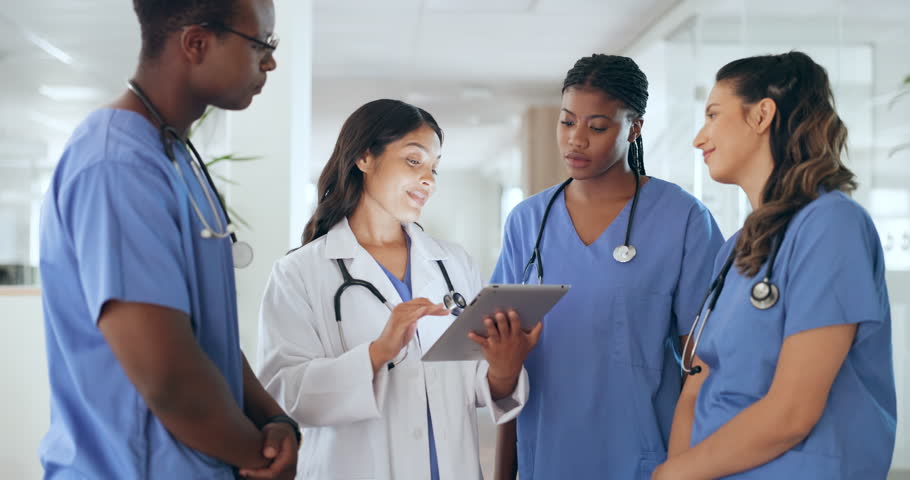 Staff, doctors and nurses with tablet, research and brainstorming for diagnosis. Team, medical professionals and teamwork for cure, discussion and talking for healthcare, analysis and conversation Royalty-Free Stock Footage #1098703147