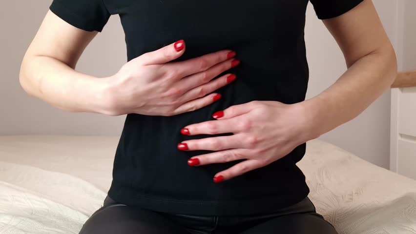 Woman with pain in stomach. She massages her belly