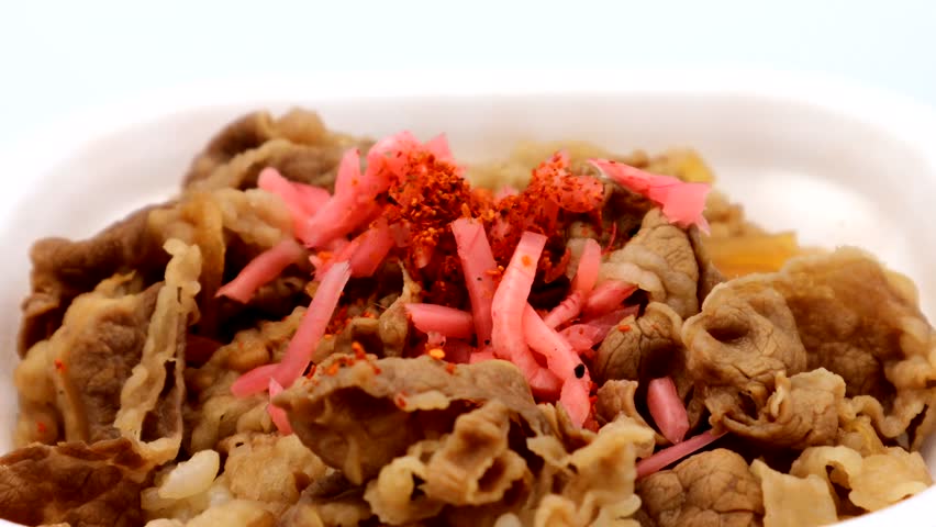 Person trying to eat beef bowl