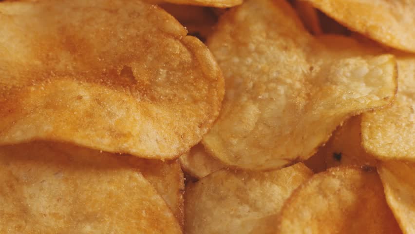 Crispy potato chips with cheddar cheese, rotating close up, macro | Shutterstock HD Video #1098708503