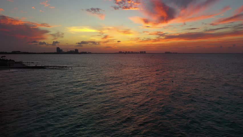 Aerial view of Dramatic sunset and evening sky over the Caribbean waterfront in Cancun.