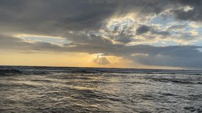 
Calming Ocean landscape, sun cloud and shining golden waves. 4K video beautiful light of nature tropical sea and open ocean waves.
