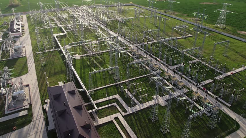 View from flying drone. High-voltage substation with switch, connectors, power lines and transformers. Electrical transformer of high tension in a distribution electric power station. High quality 4k Royalty-Free Stock Footage #1098719519