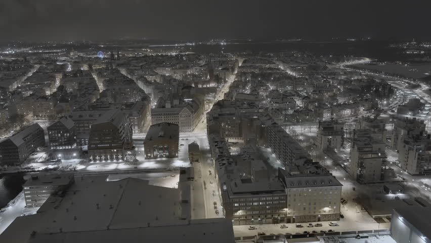 Helsinki.Finland-February 3.2022: Drone shot of a residential area in Helsinki Finland called punavuori. Amazing cityscape. Nighttime. Baltic sea coast. Wintertime. Camera slowly moving forward.