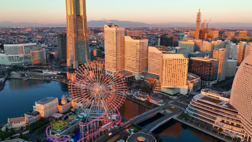 flying above Yokohama at sunrise, Japan. Seaside area in central Yokohama. Skyscrapers in the harbour in Yokohama. Establishing aerial view. High quality 4k footage