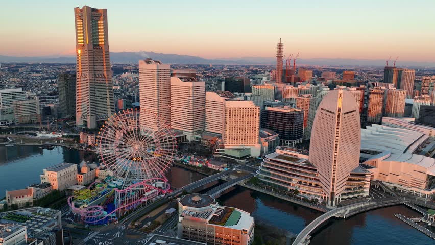 Aerial sunrise cityscape of Yokohama, Japan. Seaside area in central Yokohama. Skyscrapers in the harbour in Yokohama. Establishing aerial view