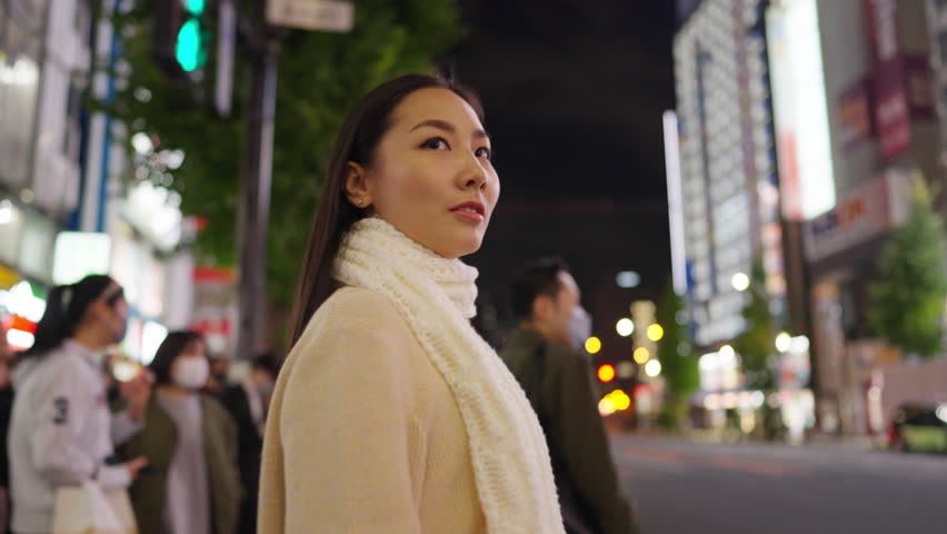 Asian woman shopping and crossing street crosswalk with crowd of people at Shibuya, Tokyo, Japan at night. Attractive girl  enjoy and fun outdoor lifestyle travel in city on autumn holiday vacation. | Shutterstock HD Video #1098721637