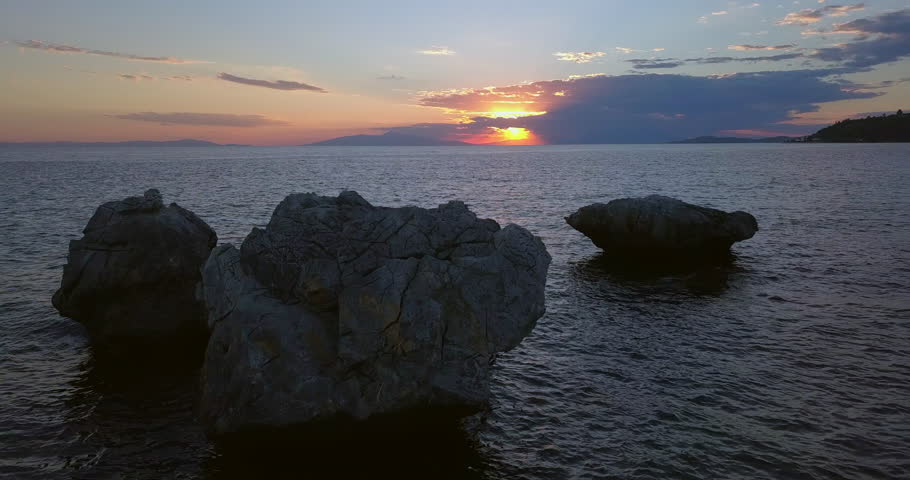 Aerial view of a rocky shore of the Aegean Sea at sunset in Greece
