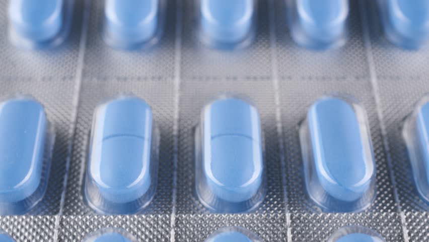 Blue pills in blister pack slider shot Royalty-Free Stock Footage #1098730041
