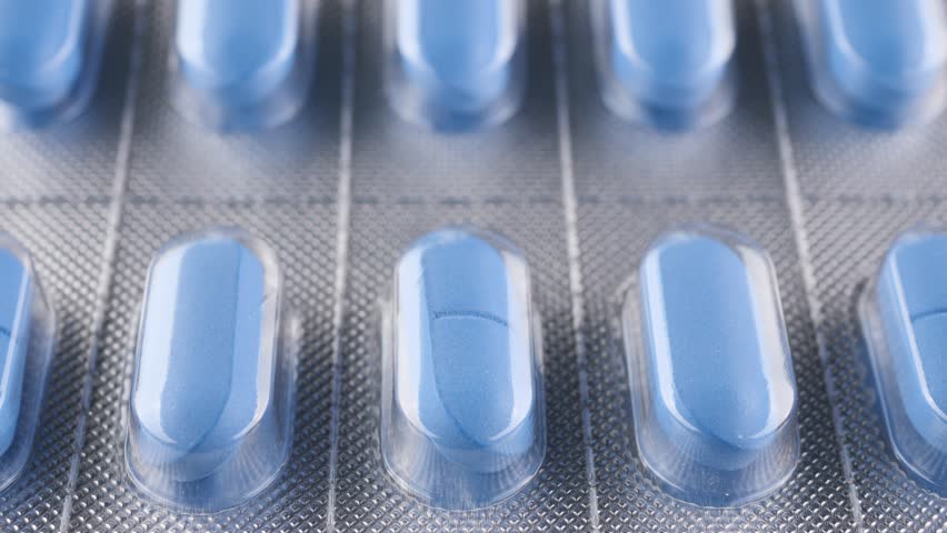 Blue pills in blister pack slider shot