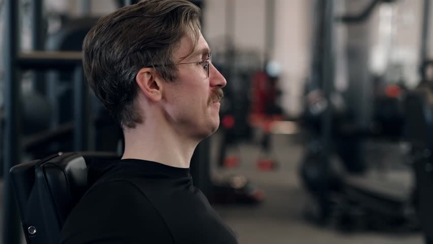 guy does exercises in the gym. High quality FullHD footage