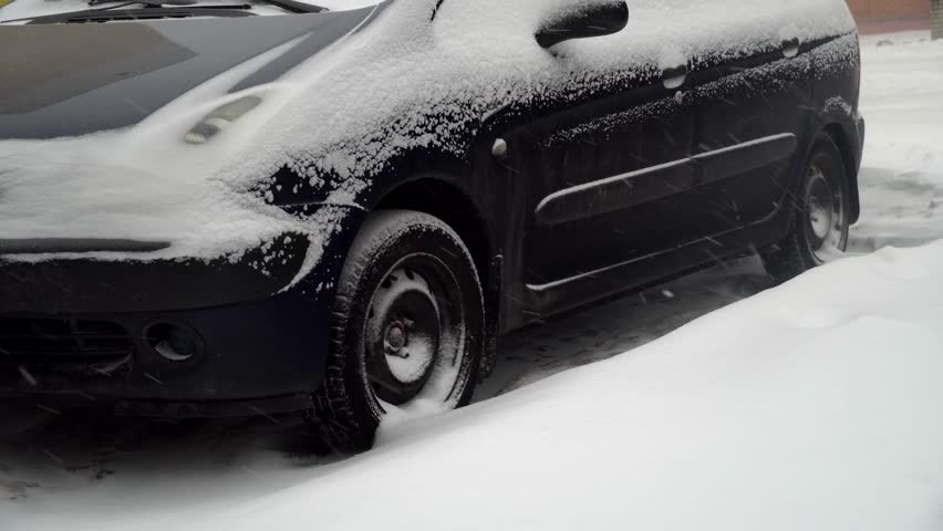 Car is parked parked. Snow storm and lots of snow on car. It's snowing. Poor road conditions. Slippery and cold. Snowstorm. abandoned autobile. | Shutterstock HD Video #1098734109