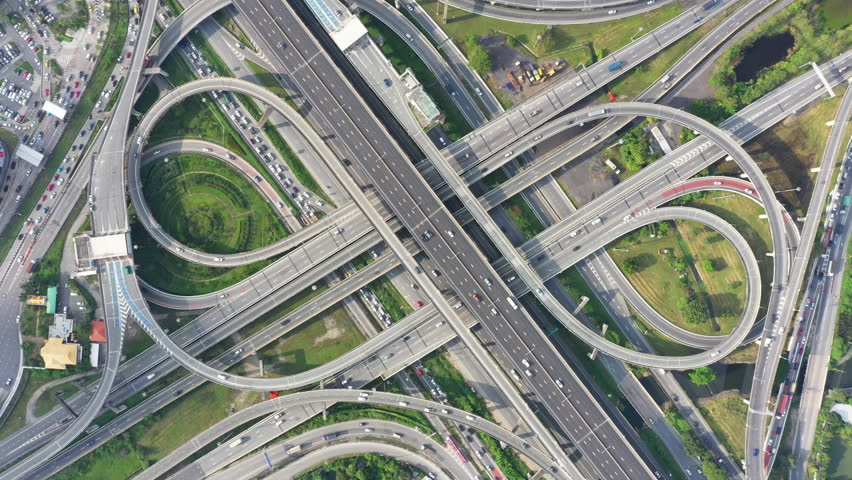 Aerial View Modern Multilevel Motorway Junction with Toll Highway, Road traffic an important infrastructure, Expressway Road and Roundabout, Transportation and travel concept. Video 4K. Royalty-Free Stock Footage #1098737897