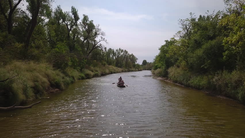 Drone shot of sailing canoe boat on a river in Tulsa, Georgia
