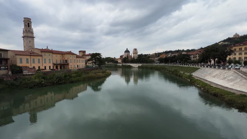 Verona ancient medieval city from Adige river on cloudy day, San Giorgio in Braida church in background. Italy