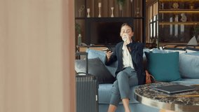 Youth Asia business female passenger wear suit sit on couch chair drink tea play phone look online booking ticket in modern airline lounge wait for transit at airport. Travel business trip concept. - Powered by Shutterstock - Get 15% off with code: PIKWIZARD15