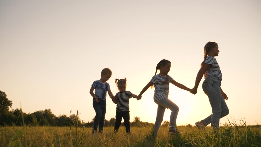 Happy family kids walk in the park together. A family of kids at sunset walks by the dreaming hands. A group of children working as a team in the park. Lots of little people. Childhood dream concept. | Shutterstock HD Video #1098740623