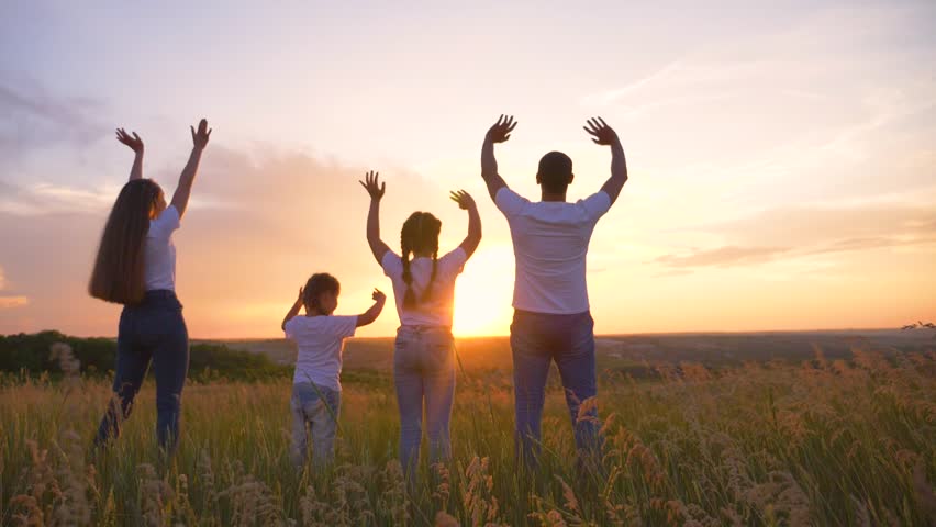 Beautiful people raise their hands up to the sun at sunset. Leisure healthy lifestyle, travel. Happy kids with parents. Happy family in the park in the open air. | Shutterstock HD Video #1098740677