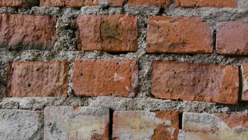 Panoramic view of the old wall close-up. A pan to right shot of a wall made out of bricks. 
Wall of old damaged red bricks. Bricks on the wall close-up.  Royalty-Free Stock Footage #1098742589