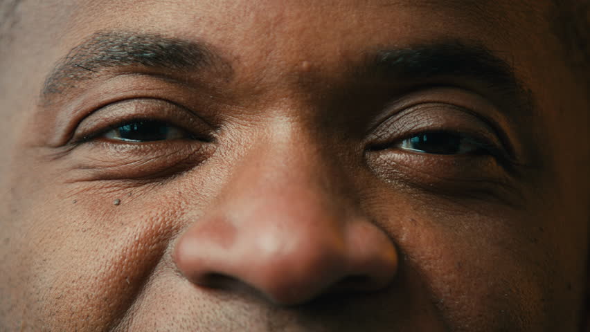 Extreme close-up view male eyes happy joyful african american man looking at camera pleased client satisfied with ophthalmology surgery or professional optical eye correction operation clinic services Royalty-Free Stock Footage #1098743103