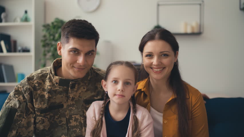 Portrait of young soldier with his wife and daughter, happy family, true love