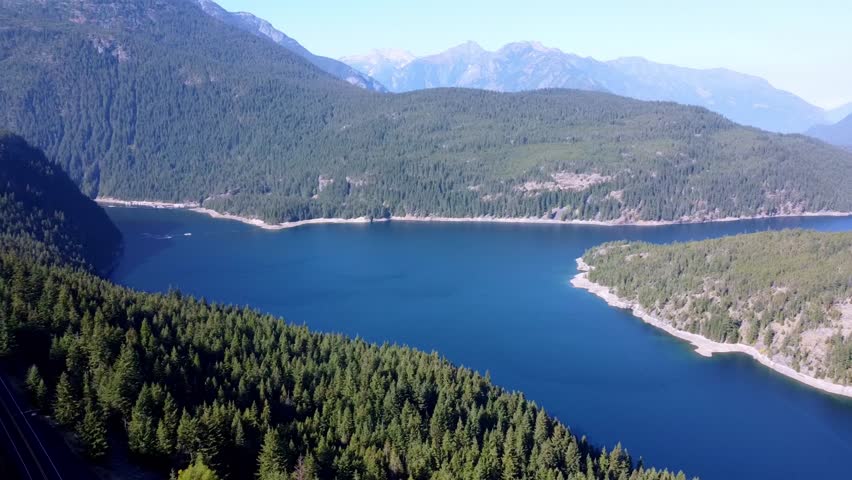 Drone aerial flyaway view of Ross Lake off Rte 20 close to Ruby Mountain in Washington State | Shutterstock HD Video #1098747079