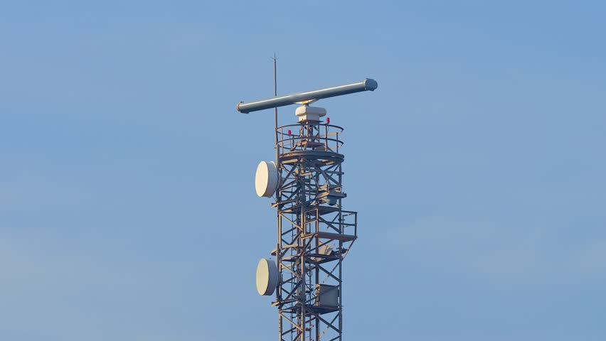 Radar Tower Beacon against a blue sky on a sunny day. Metal truss construction. | Shutterstock HD Video #1098747213