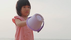 Video asian kid play sand on the beach. Background for family life and education.