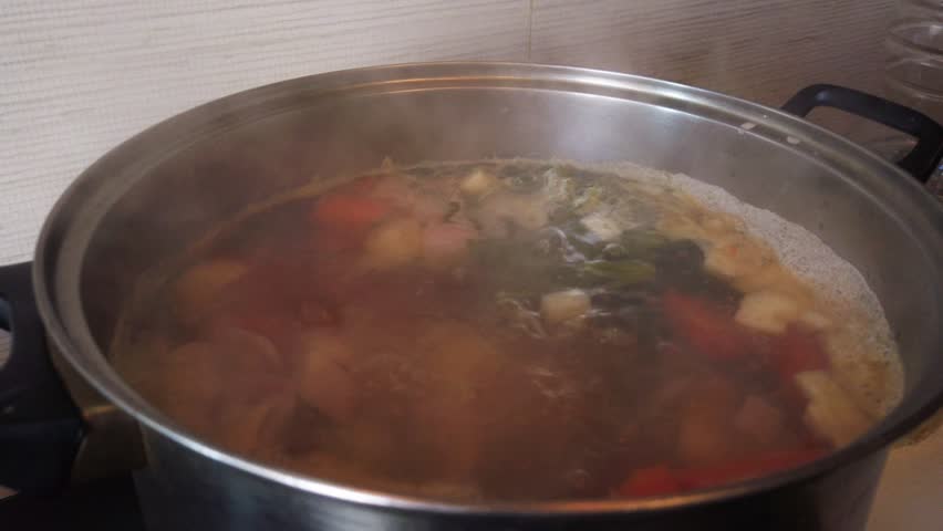 Cooking soup. Overhead view of the pot with boiling vegetables. Vegeteranean food. High quality 4k footage