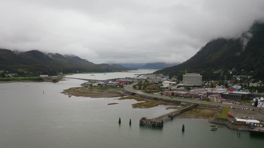 Pier And Coastal Town On An Overcast Day In Alaska. - aerial