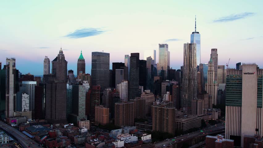 New York , United States - 11 21 2022: Aerial view in front of high-rise in lower Manhattan, dawn in NY, USA - tracking, drone shot