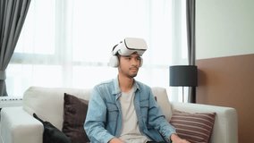 
Excited young Asian man putting on a VR virtual reality headset to feel excited in the living room at home. Playing game in augmented reality at home - Powered by Shutterstock - Get 15% off with code: PIKWIZARD15