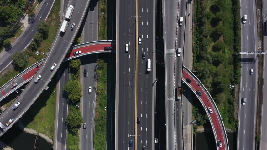 Aerial View Modern Multilevel Motorway Junction with Toll Highway, Road traffic an important infrastructure, Expressway Road and Roundabout, Transportation and travel concept.  Vdo 4K. Royalty-Free Stock Footage #1098759321